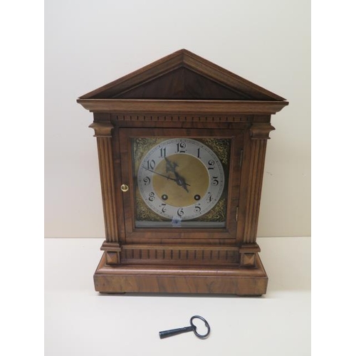 154 - A walnut striking mantle clock, in working order, 38cm tall