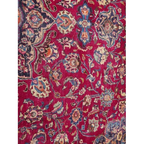 205 - A large hand knotted Persian woollen rug, some patches of wear consistent with use, 397cm x 292cm