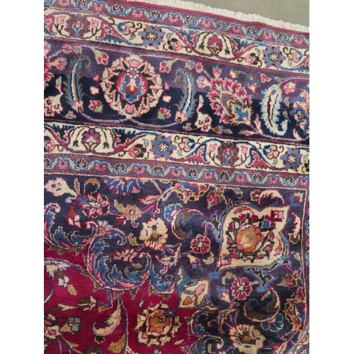 205 - A large hand knotted Persian woollen rug, some patches of wear consistent with use, 397cm x 292cm