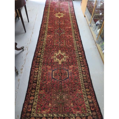 207 - A hand knotted woollen Karajeh rug, 4.00m x 1.0m