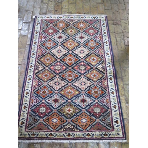 209 - A hand knotted woollen Baluchi rug, 1.45m x 1.10m