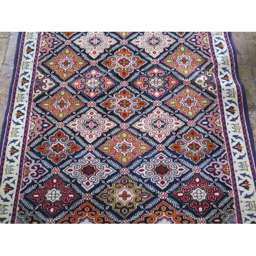 209 - A hand knotted woollen Baluchi rug, 1.45m x 1.10m