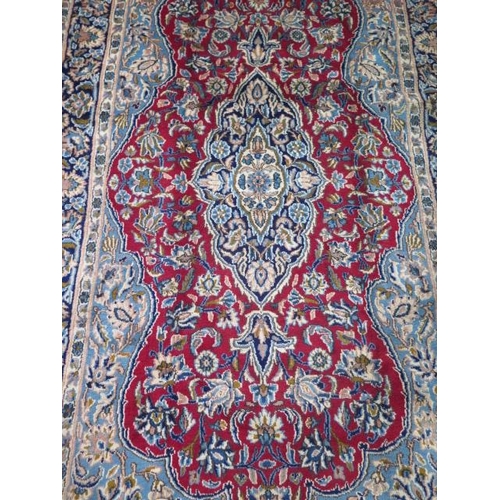 215 - A hand knotted woollen Isphihan rug, 2.40m x 1.30m