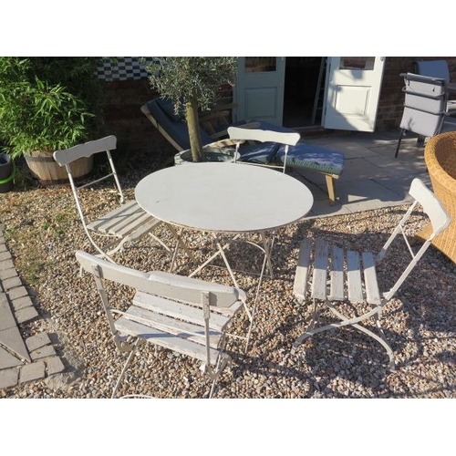 30 - A metal folding garden table, 86cm diameter, and 4 folding chairs