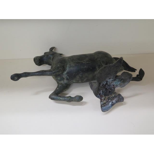 303 - An Oriental bronze metal galloping horse, 33cm tall