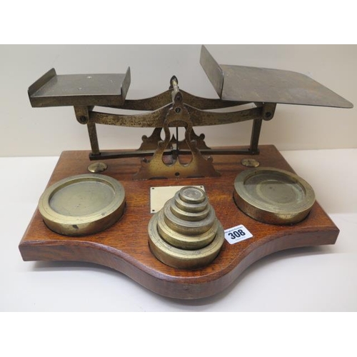 308 - A set of balance scales with weights on an oak base stamped Warranted Accurate