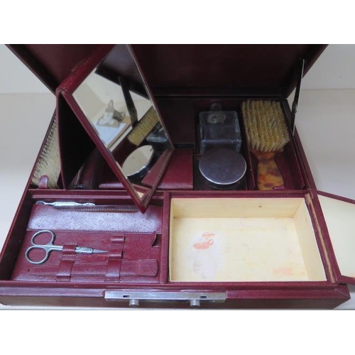 317 - A vintage red leather fitted travel case with bottles, brushes and other fittings, 14cm x 37cm x 30c... 