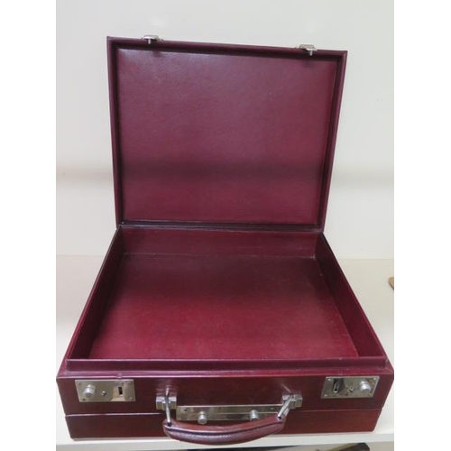 317 - A vintage red leather fitted travel case with bottles, brushes and other fittings, 14cm x 37cm x 30c... 