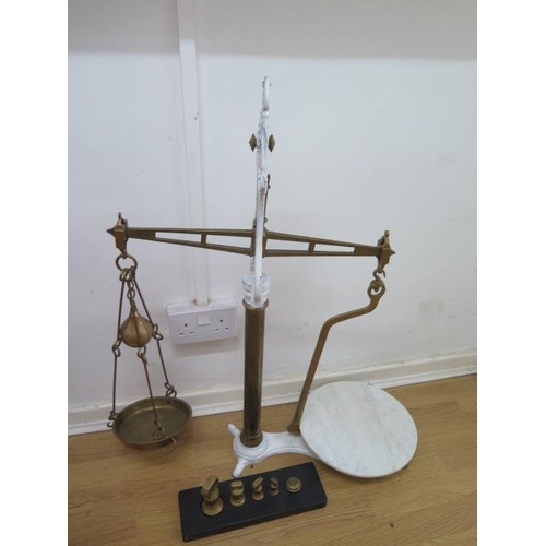 318 - A brass and iron set of butter scales, with weights and marble plate, 83cm tall