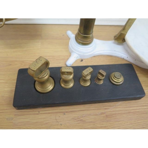 318 - A brass and iron set of butter scales, with weights and marble plate, 83cm tall