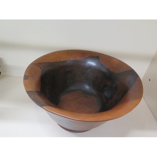 32 - A  footed  turned wooden bowl, 21cm tall x 40cm diameter