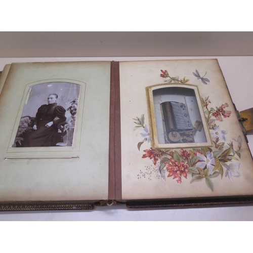 326 - A Victorian musical clasped photograph album with 13 floral designed leaves showing 5 cabinet photog... 