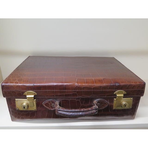 331 - A good quality early 20th century crocodile skin leather suitcase in good polished condition, recent... 