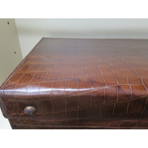 331 - A good quality early 20th century crocodile skin leather suitcase in good polished condition, recent... 