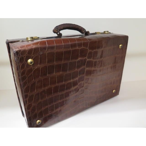 331 - A good quality early 20th century crocodile skin leather suitcase in good polished condition, recent... 