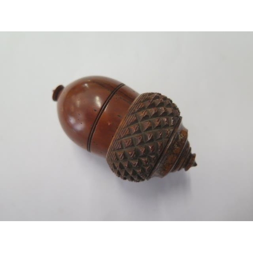 333 - A 19th century carved nutmeg grater with bone insert, 7.5 cm tall, in generally good condition