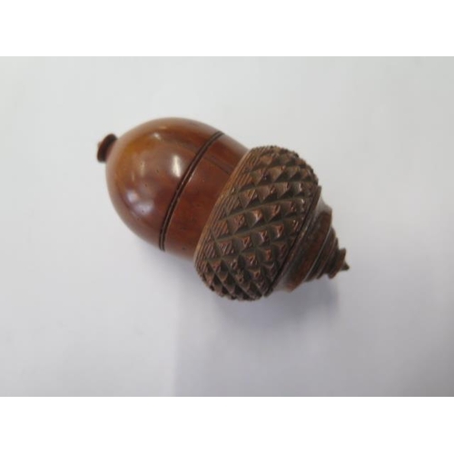 333 - A 19th century carved nutmeg grater with bone insert, 7.5 cm tall, in generally good condition