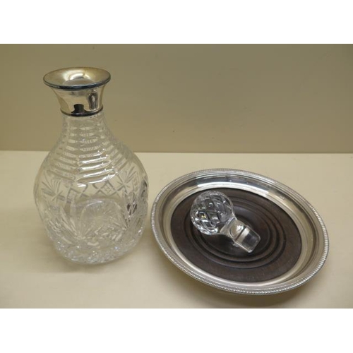 419 - A cut glass decanter with a silver collar, 26cm tall, Birmingham 1991 PHV & Co, and a silver and woo... 