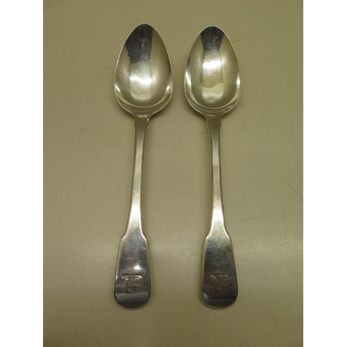 435 - A good pair of George III silver fiddle pattern table spoons with a serpent monogram by William Eley... 