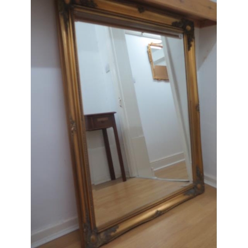 44 - A decorative gilt wall mirror, 116cm x 90cm