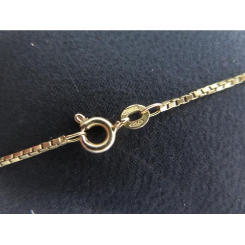 466 - A 750 18ct yellow gold 50cm chain, an 18ct pendant, a gilt ball pendant and a yellow gold charm, tot... 