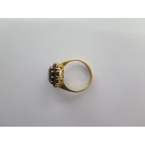 467 - An 18ct yellow gold garnet ring, size M, approx 5.3 grams, generally good