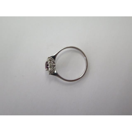 475 - A 9ct white gold garnet and diamond ring, size P/Q, approx 2.5 grams, head 11mm x 9mm, in good condi... 