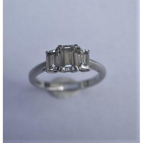 484 - A hallmarked Tiffany & Co 950 platinum 3 stone baguette cut diamond ring, the central diamond approx... 