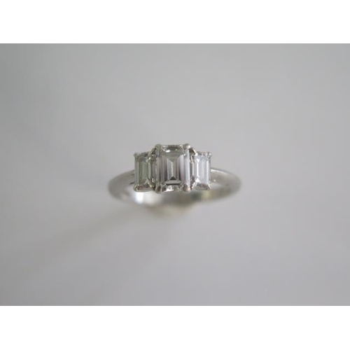 484 - A hallmarked Tiffany & Co 950 platinum 3 stone baguette cut diamond ring, the central diamond approx... 