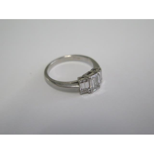 484 - A hallmarked Tiffany & Co 950 platinum 3 stone baguette cut diamond ring, the central diamond approx... 