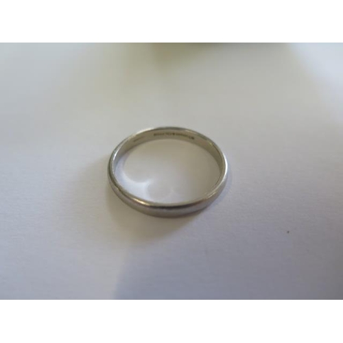 486 - A hallmarked Tiffany & Co 950 platinum band ring, size X, approx 5.4 grams, some usage marks but gen... 