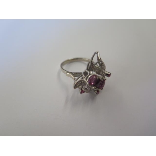 487 - A ruby and diamond flower spray designer ring set in palladium, size M, head approx 21mm x 21mm, app... 