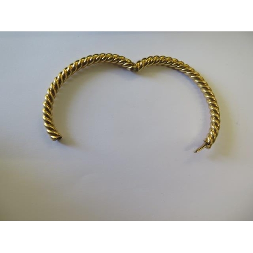 491 - A hallmarked 18ct 750 rope twist hinged bangle, 7cm x 6cm external, approx 31.8 grams, good conditio... 