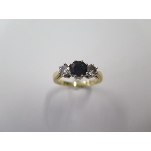 499 - An 18ct yellow gold sapphire and diamond trilogy ring, the central sapphire approx 0.73ct with the t... 