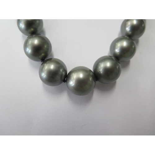 511 - A good string of black 'Rio Pearl' pearls with a 14ct white gold clasp, 48cm long, graduating from 1... 