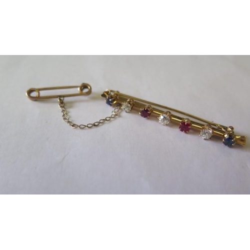 518 - An early 20th century yellow metal bar brooch set with three old cut diamonds, 2 cushion cut sapphir... 