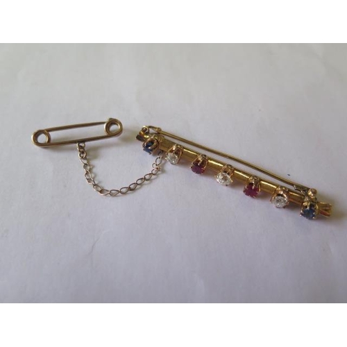 518 - An early 20th century yellow metal bar brooch set with three old cut diamonds, 2 cushion cut sapphir... 