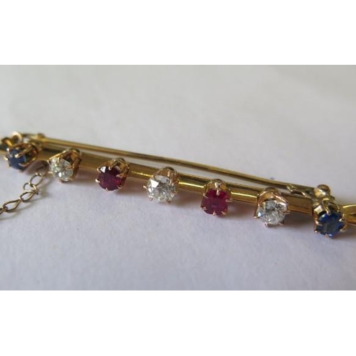 518 - An early 20th century yellow metal bar brooch set with three old cut diamonds, 2 cushion cut sapphir... 