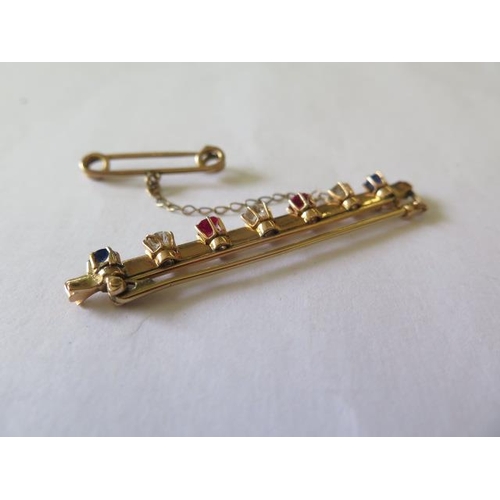 518 - An early 20th century yellow metal bar brooch set with three old cut diamonds, 2 cushion cut sapphir... 