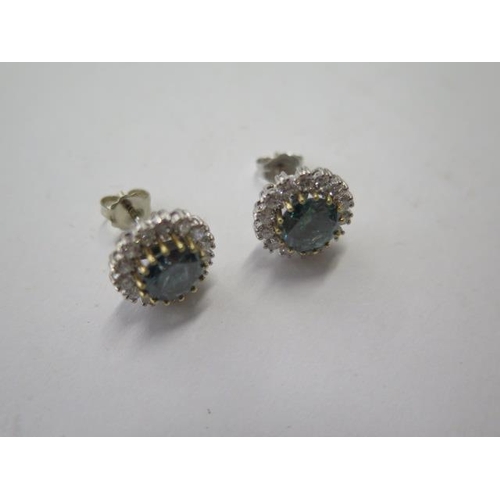 522 - A pair of 18ct white gold diamond cluster earrings, treated blue round brilliant cut diamonds each s... 