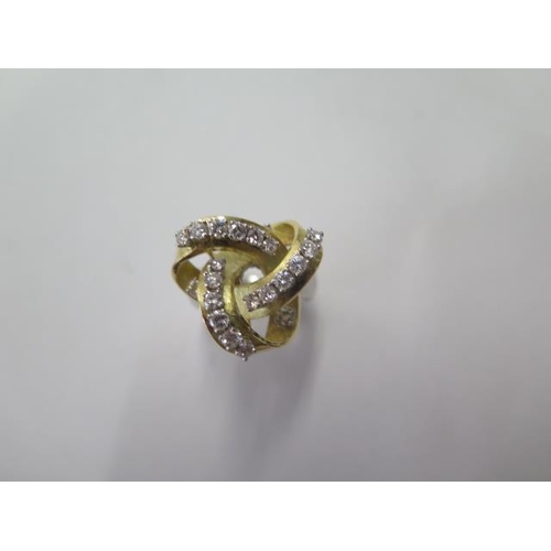 523 - An unusual white and yellow gold diamond set knot ring, set with 20 round brilliant diamonds, total ... 