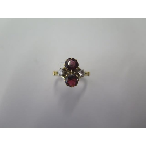 525 - A hallmarked 18ct yellow gold garnet and diamond ring with spacers making it size H, approx 4.9 gram... 