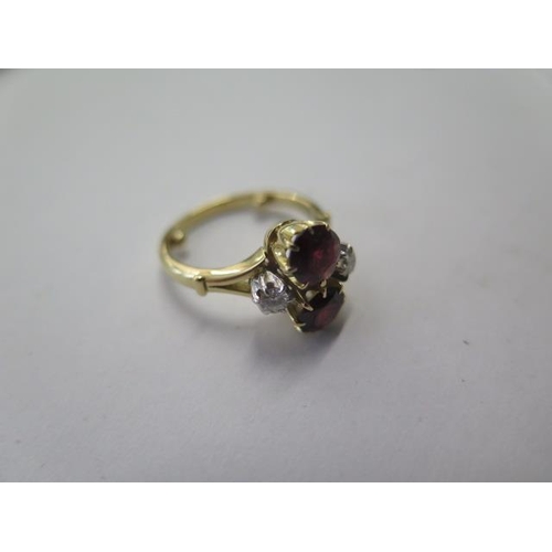 525 - A hallmarked 18ct yellow gold garnet and diamond ring with spacers making it size H, approx 4.9 gram... 