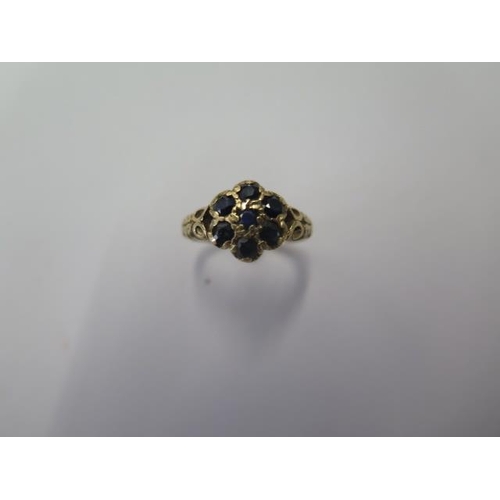 534 - A 9ct yellow gold seven stone ring, size J, approx 2.6 grams, some wear but generally good