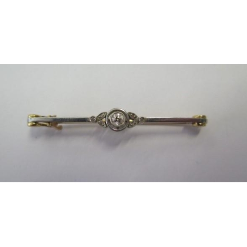 535 - A yellow gold diamond bar brooch, 52mm long, approx 4.3 grams, tests to approx 18ct, some bending to... 