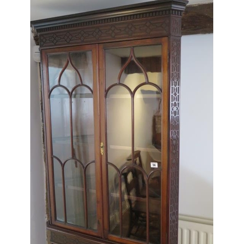 56 - An Edwardian mahogany corner cabinet with an astragel glazed top over a 2 door base with blind fretw... 