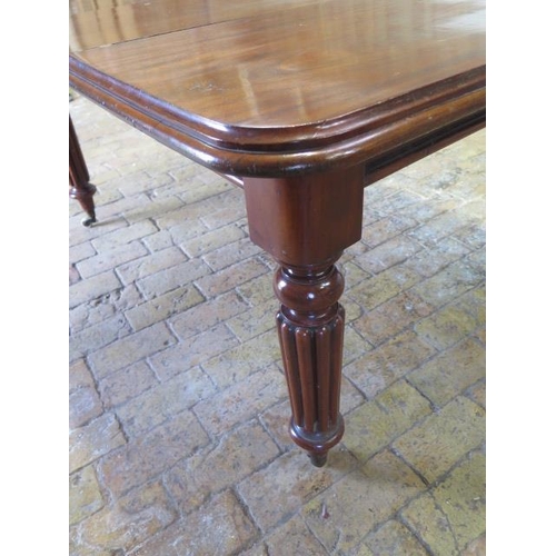 71 - A 19th century mahogany dining table with a single leaf on reeded legs, in good condition, with its ... 