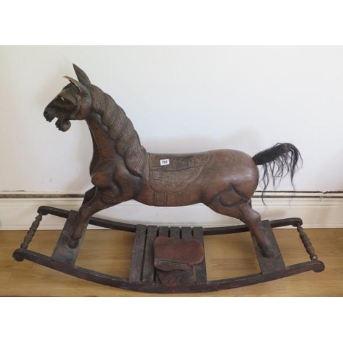 736 - A carved wooden rocking horse, 86cm tall, some wear mainly to saddle and an ear