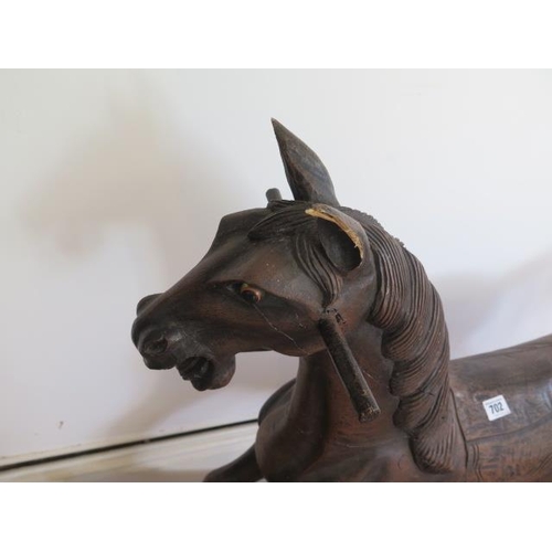 736 - A carved wooden rocking horse, 86cm tall, some wear mainly to saddle and an ear