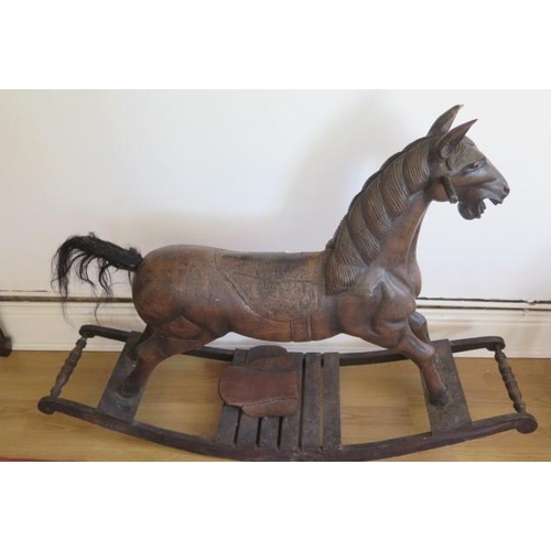 736 - A carved wooden rocking horse, 86cm tall, some wear mainly to saddle and an ear